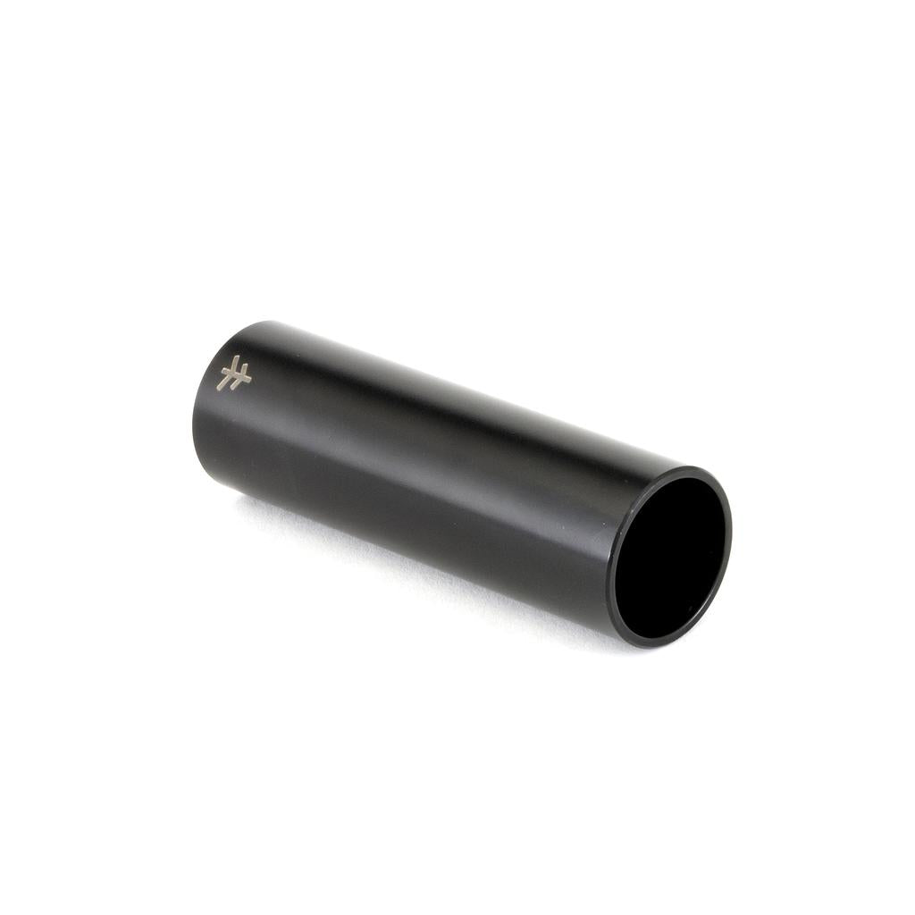 The Fly Bikes Acero ST Peg, a black cylindrical tube machined from 4140 Cr-Mo alloy, is placed horizontally on a white surface, showcasing a small logo near one end.