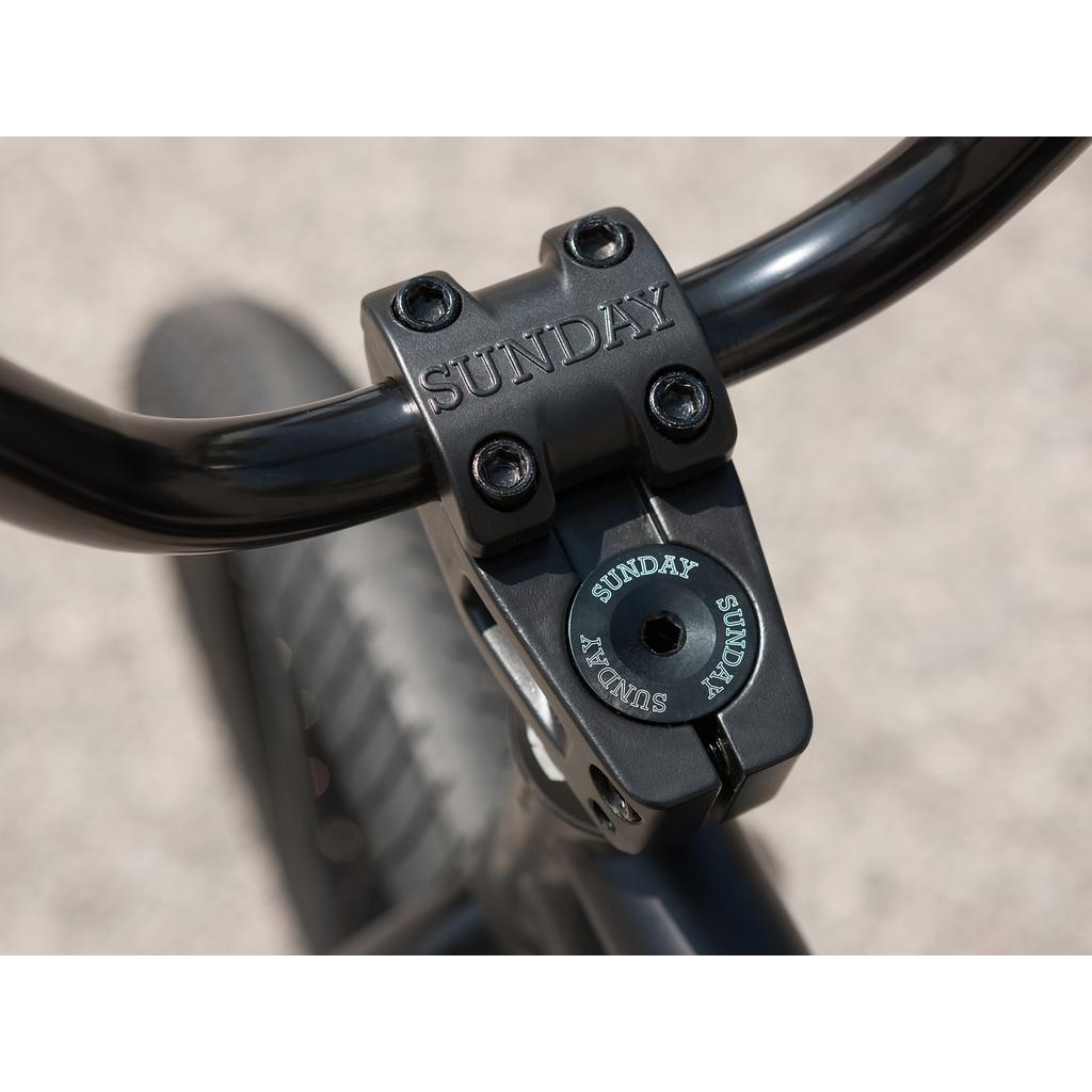 Close-up of a black handlebar stem with "SUNDAY" branding on the Sunday Forecaster 20 Inch Bike (2025) / Broc Raiford, featuring a 100% chromoly frame.
