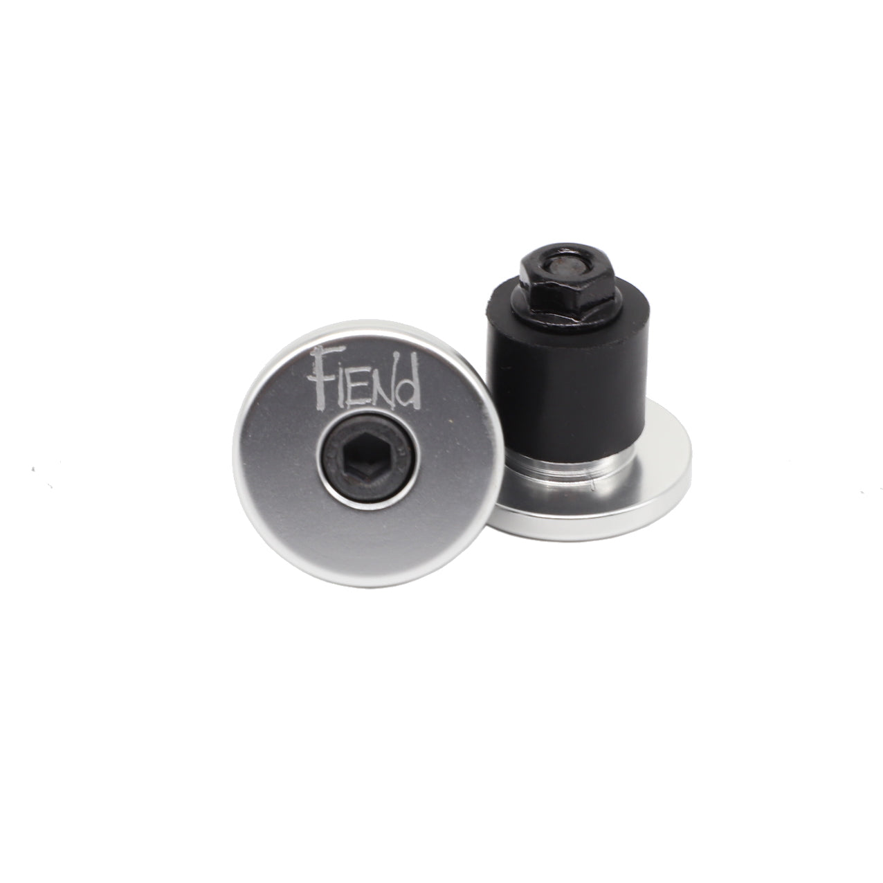 Two Fiend Alloy Bar Ends in silver and black metal are shown, one standing upright and the other lying flat with “FIEND” engraved on the end, providing durable protection for your bike’s handlebars.