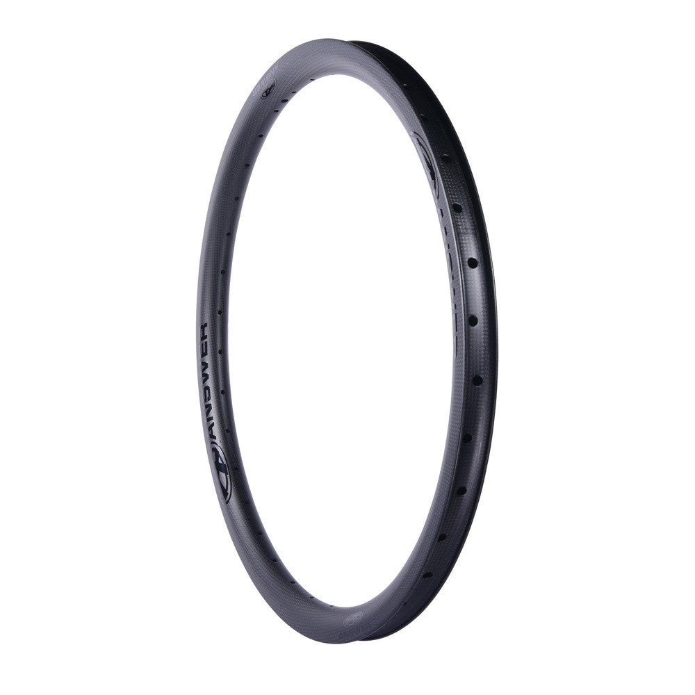 A black Answer BMX Pro Carbon rim isolated on a white background, featuring etched brand details.