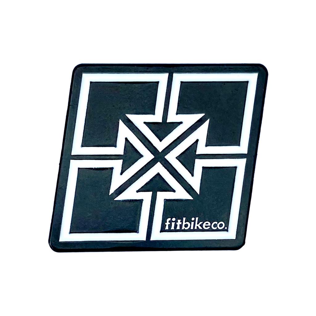 A black square patch with a white geometric line design and "fitbikeco." text in the corner—ideal to pair with your Fit Bike Co Key Enamel Pin.