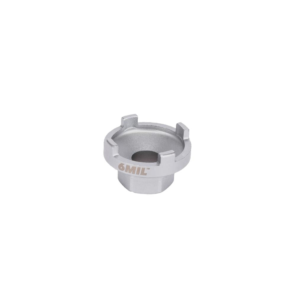 The 6MIL Freewheel Removal Tool (16T) is a silver metallic part made from heat-treated steel, featuring a center hole and four raised notches, designed for BMX freewheel removal, displayed on a plain white background.