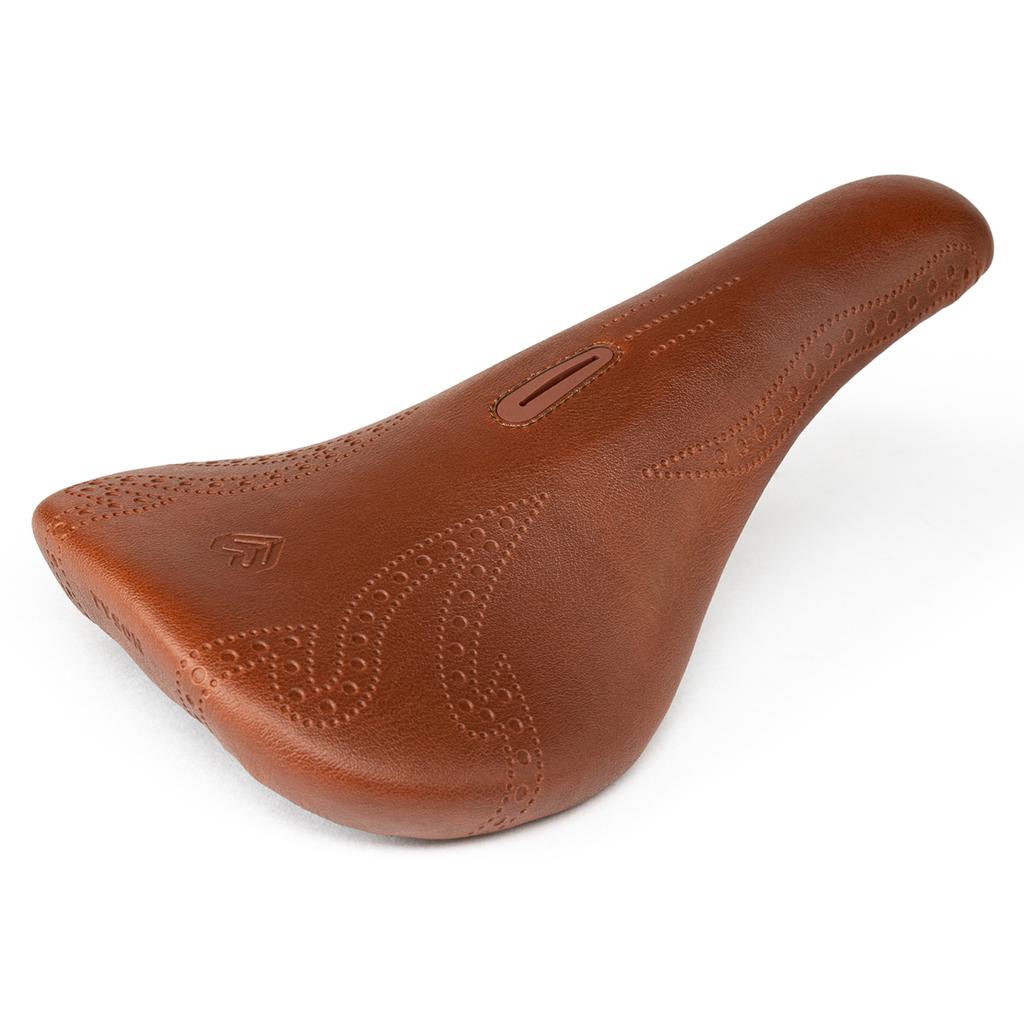 The Eclat Exile Pivotal Seat / Tyson features brown leather, decorative stitching, and a small Exile logo on the side, displayed against a white background.