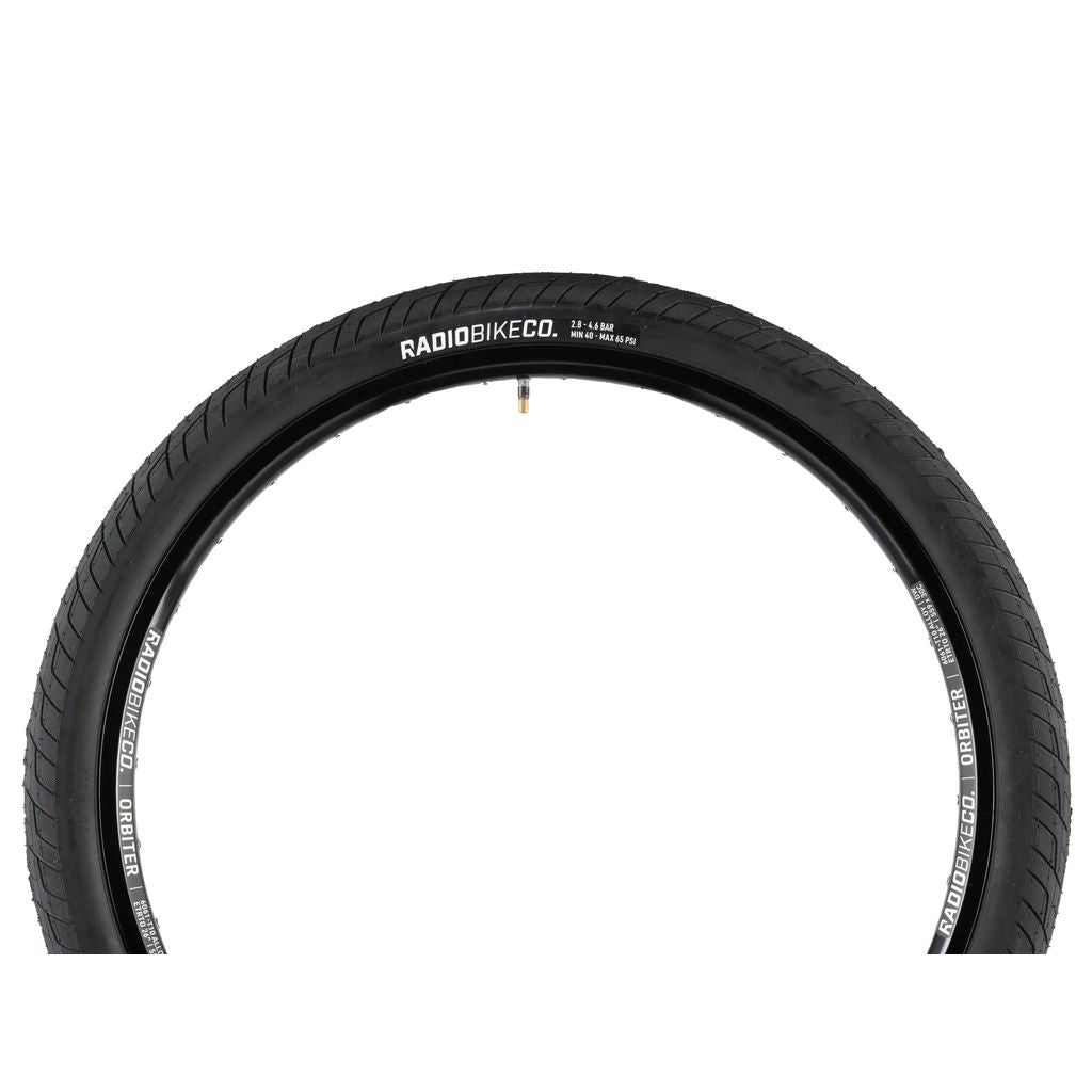 The Radio Stratus 26" tire features a durable build, sleek black finish, and strategically placed valve stem, making it perfect for all-terrain adventures.