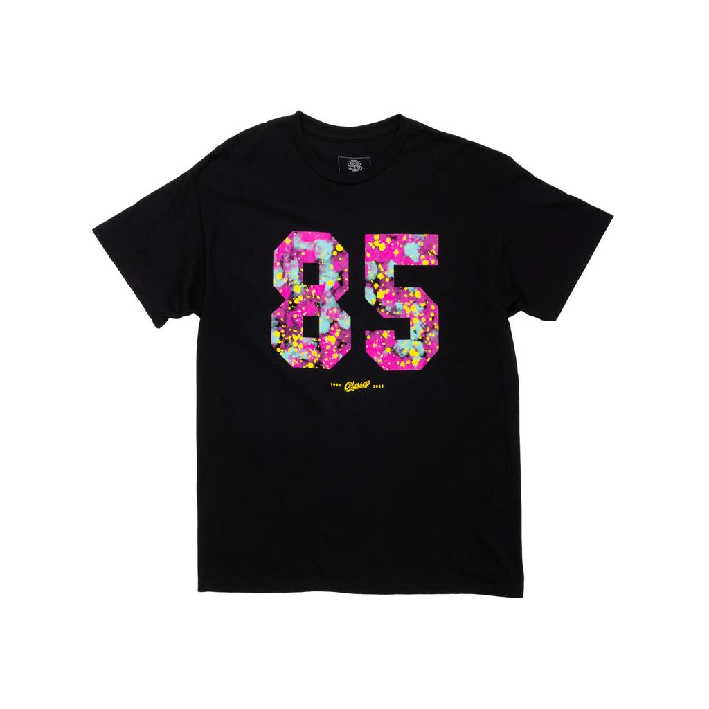 The Odyssey 85 Splatter T-Shirt features a bold "85" in colorful floral print on the chest with small yellow text beneath—an eye-catching standout from our splatter line.