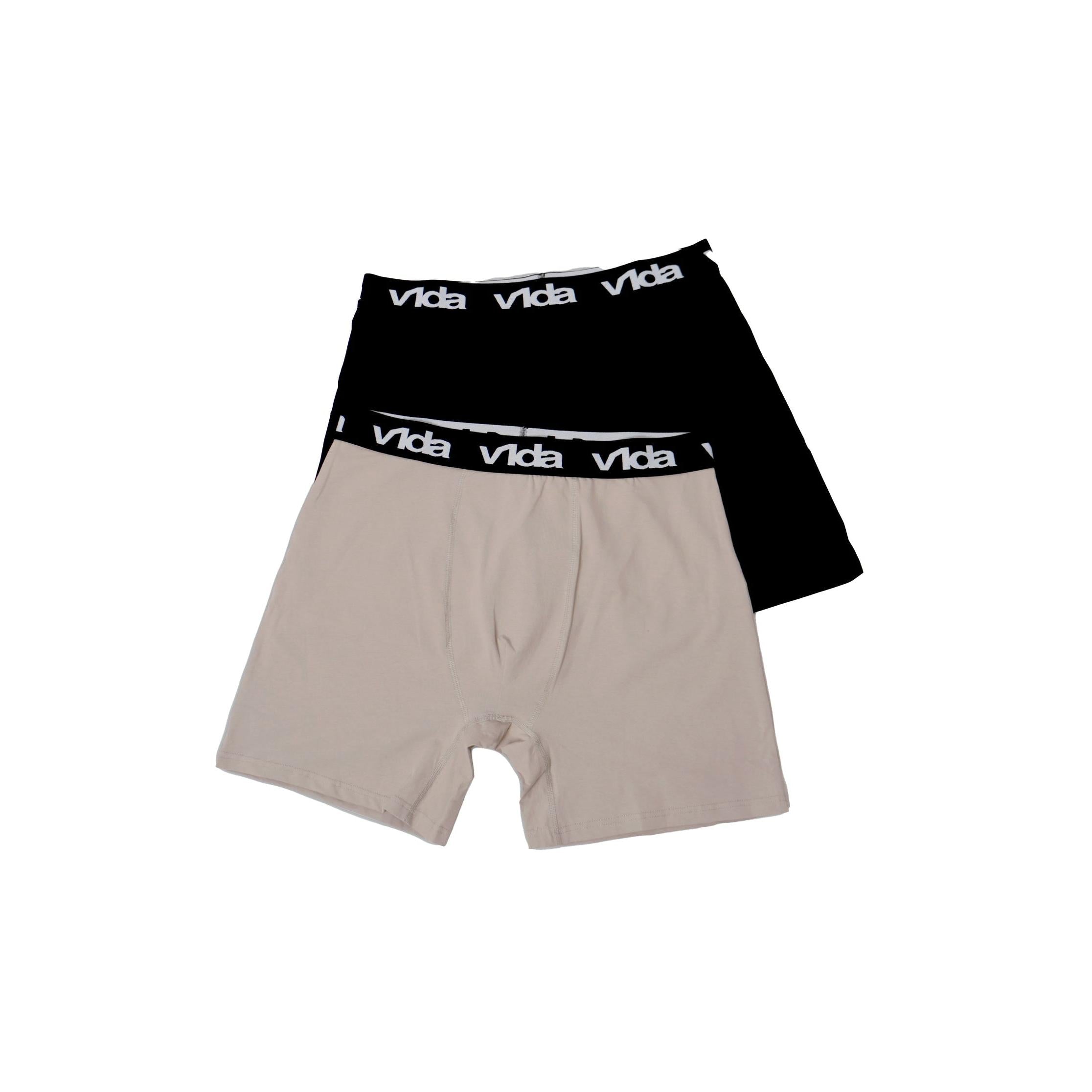 The V1da Boxer Briefs (2 Pack) includes one black and one beige men's mid-length cotton boxer, both with updated design and black elastic waistbands featuring the white "Vida" logo, displayed on a white background.