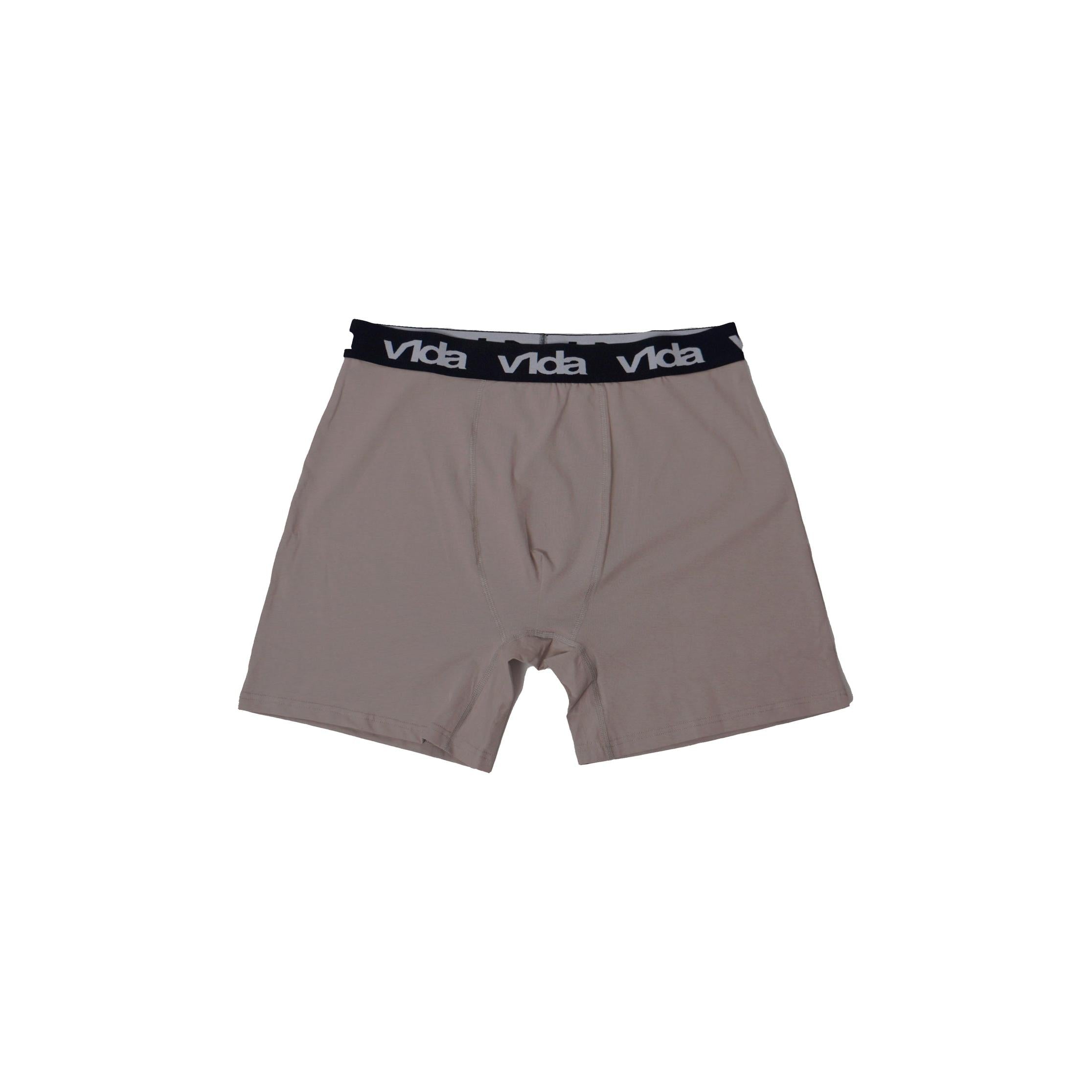 The V1da Boxer Briefs (2 Pack) are beige men's mid-length cotton boxers with a black waistband featuring repeated white "Vida" text, updated for comfort.