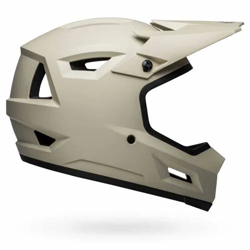 The Bell Sanction 2 Matte Cement is a matte beige full-face BMX helmet with angular vents and a visor, displayed side profile on a white background—an ideal entry-level choice for new riders.