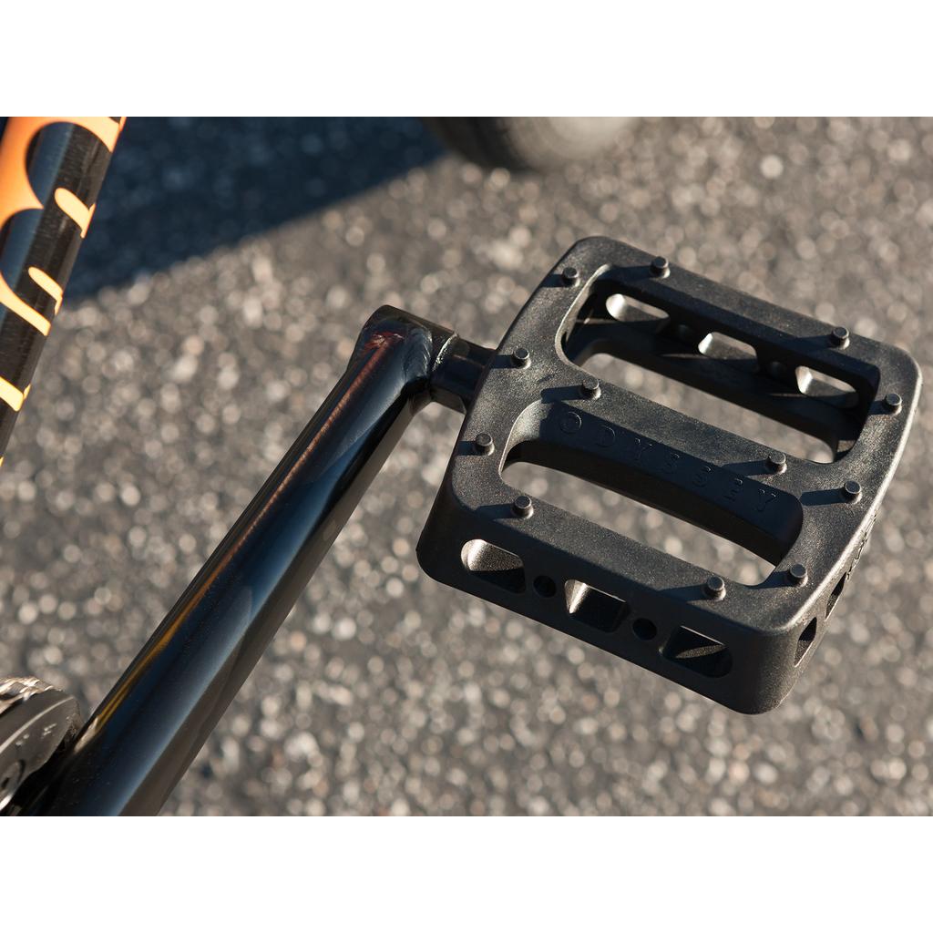 A black bicycle pedal on a black metal pole, designed for the Sunday Sound Wave Special 20 Inch Bike (2023), and compatible with Odyssey BMX parts.