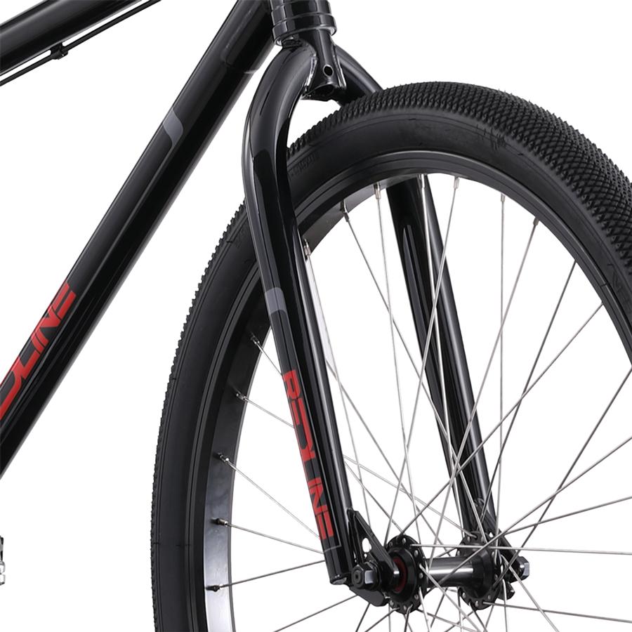 Close-up of a Redline PL 26 Inch Bike’s front wheel, displaying the tire, spokes, fork, and part of the black chromoly steel frame with red lettering.