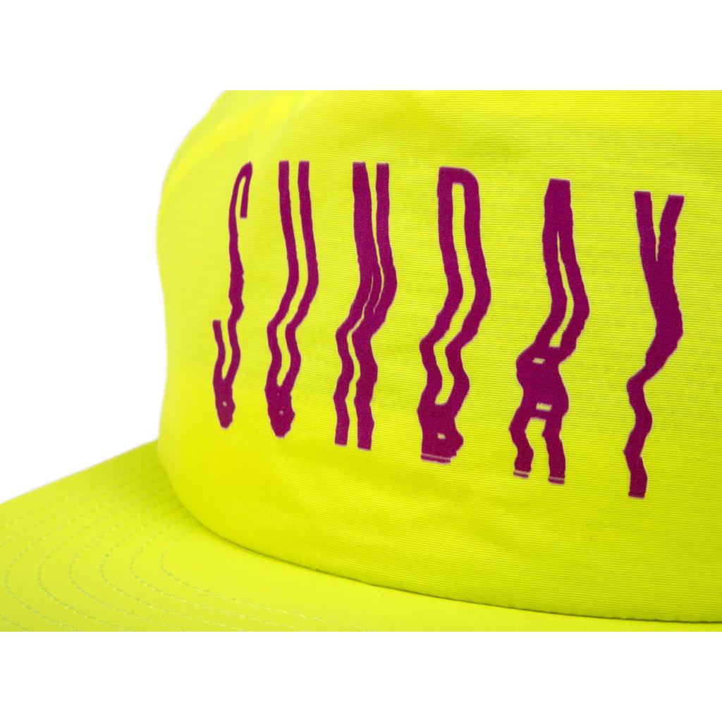 The Sunday High Wave Cap is a yellow Snap Back with "SUNDAY" in bold wavy purple letters—perfect for your Back to School 2025 style.