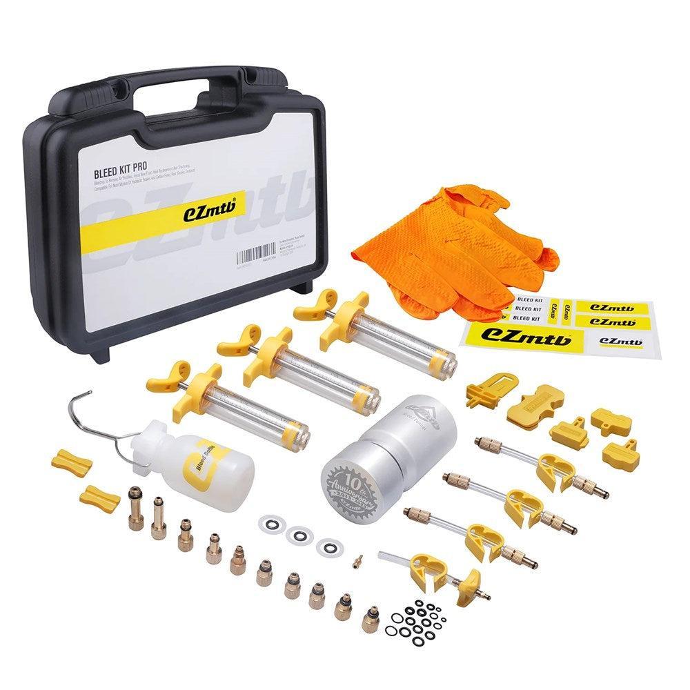 The EZ MTB Universal Bleed Kit – Workshop Model includes syringes, gloves, a fluid container, adapters, small parts, and a carrying case—all organized on a white background for easy bicycle maintenance.