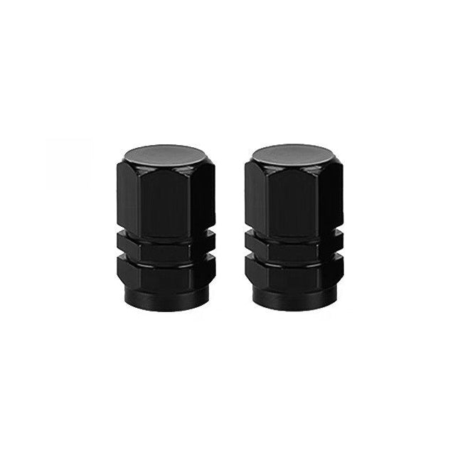 The Hexagon Valve Caps (Pair) are sleek black and set against a pristine white background, ready to enhance your ride.