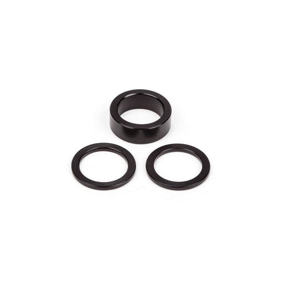 A set of black BSD West Coaster Gap Washers and rings on a white background, perfect for West Coaster Hubs and as a spare gap washer kit.
