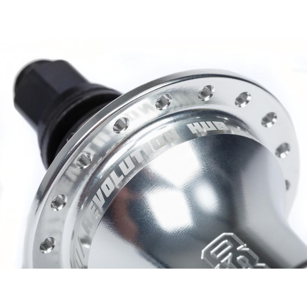 Close-up of a shiny metallic hub with engraved "BSD Revolution Rear Freecoaster Hub" text and bolt holes around its edge, showcasing an innovative design.