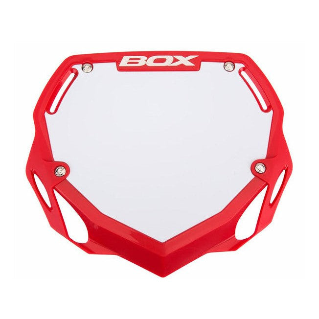 A Box Two Phase 1 Number Plate Large in red and white plastic, designed for a BOX Component motocross or BMX bike, featuring multiple attachment points. Ideal for riders in the UCI/GSX Super Cross Series.