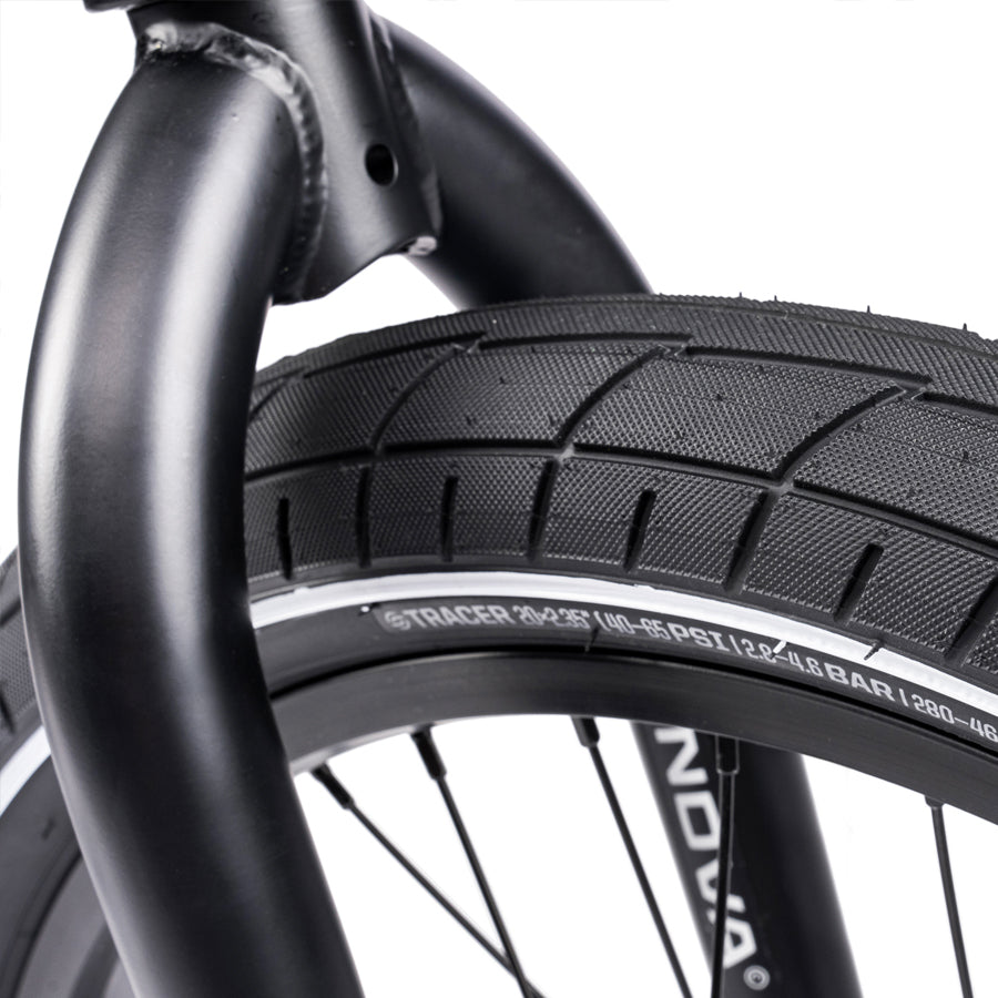 A close up of a black Wethepeople Nova 20 Inch BMX tire on a white background featuring the Wethepeople Nova 20 Inch BMX bike.