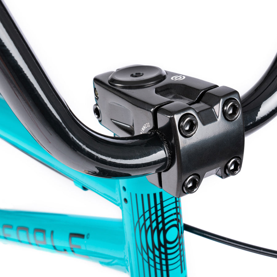A close up of the handlebar on a Wethepeople Nova 20 Inch BMX bike in turquoise color.