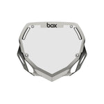 The Box TWO Number Plate / Large Silver Chrome features silver and white colors, four mounting holes, angular side cutouts, and the "box" logo at the top—ideal for riders who want to hit the track in style.