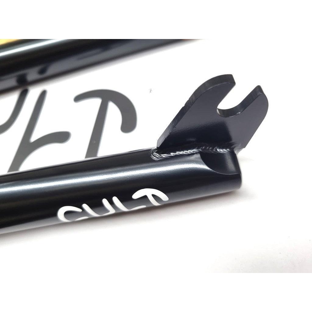 Close-up of a black metal bike frame featuring a welded joint, partially displaying the "CULT" text in white, seamlessly paired with Cult Sect V4 20 Inch Forks that have a 32mm offset.