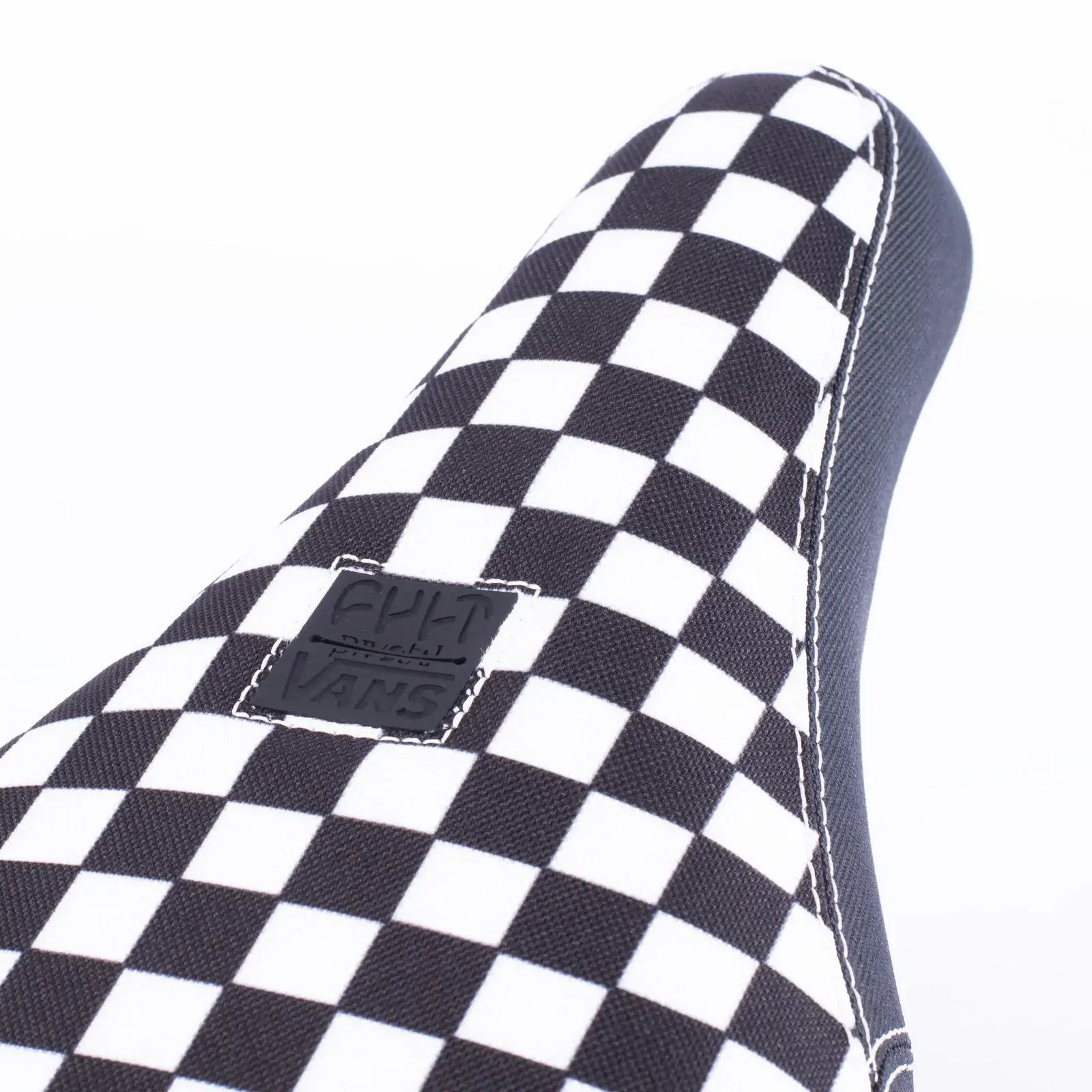 Close-up of the Cult Vans Slip On Checker Pivotal Seat, showcasing its limited edition checkered pattern and a small Vans logo patch.