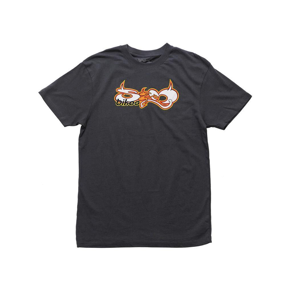 The S&M Devil Letters T-Shirt is a dark gray heavyweight cotton tee with an abstract orange, white, and yellow "bikes" graphic on the front, inspired by classic old-school BMX shirt style.