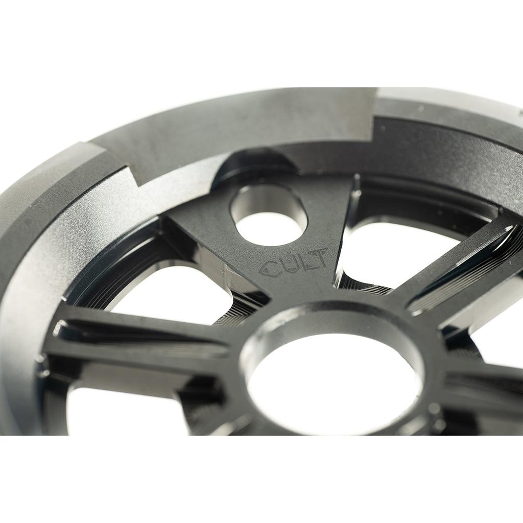 Close-up of the cult-dak-guard-sprocket in black, featuring "CULT" engraved on its 7075-T6 aluminium surface.