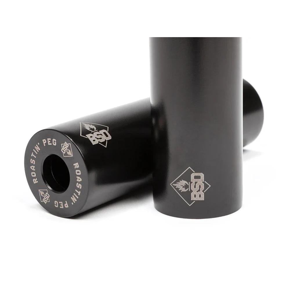 A single BSD Roastin Peg—black, cylindrical, made from durable 4140 chromoly with white "ROASTIN' PEG" and "BSD" logos on the ends and sides. Perfect as a stylish BMX grind peg.