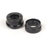 The Eclat Kolibri Cone Set includes two black, round metal knurled thumb nuts with textured edges, perfect as replacement cones or bike hub parts for your Kolibri rear hub, shown side by side on a white background.