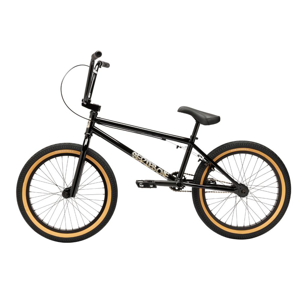 A black Fit Bike Co Series One Bike BMX with tan tires, straight handlebars, and a Cro-Mo frame features a single gear and is shown on a white background.