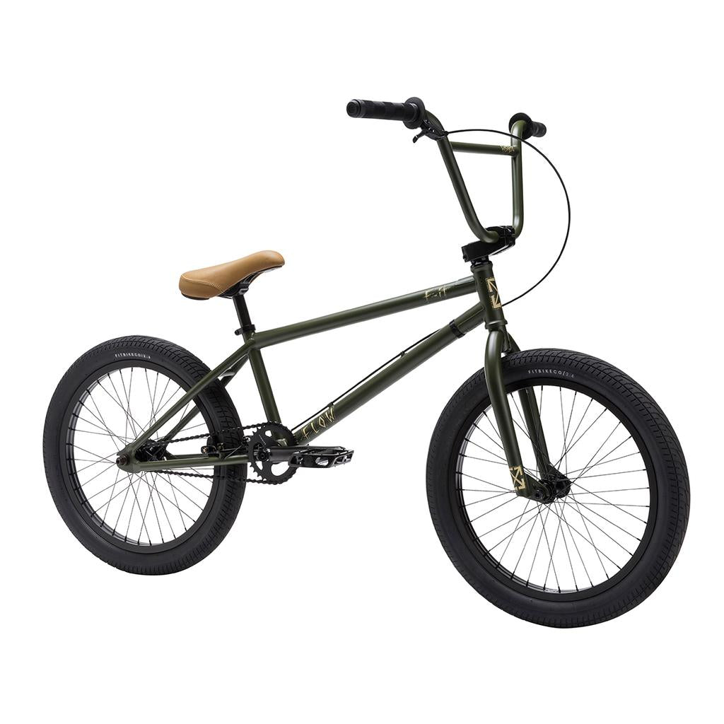 A Fit Bike Co Flow 20 Inch BMX bike in green, featuring a tan seat, black handlebars, and black tires, displayed at an angle against a white background.
