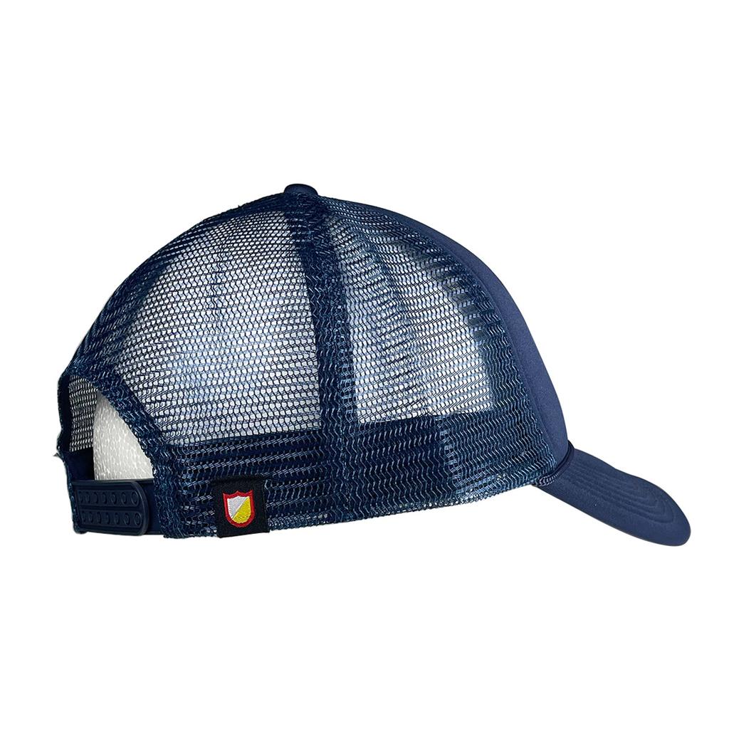 The S&M Rambler Sharpie Shield Cap is a blue mesh-back hat seen from the rear, featuring a snapback closure and a small red and yellow shield patch above the adjustable strap.