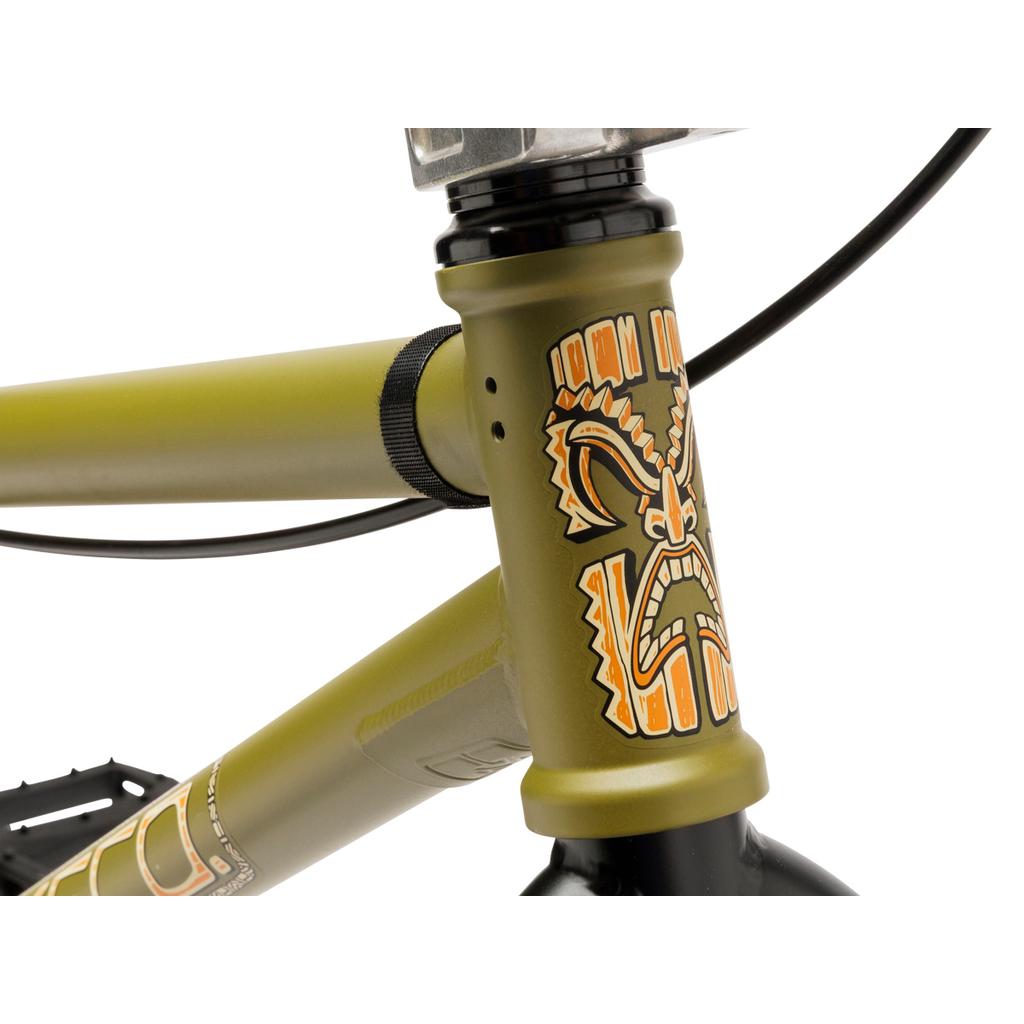 Close-up of the Fit Bike Co Misfit 18 Inch Bike in olive green, featuring a vibrant tiki face graphic on the head tube—an ideal choice for young BMX riders.