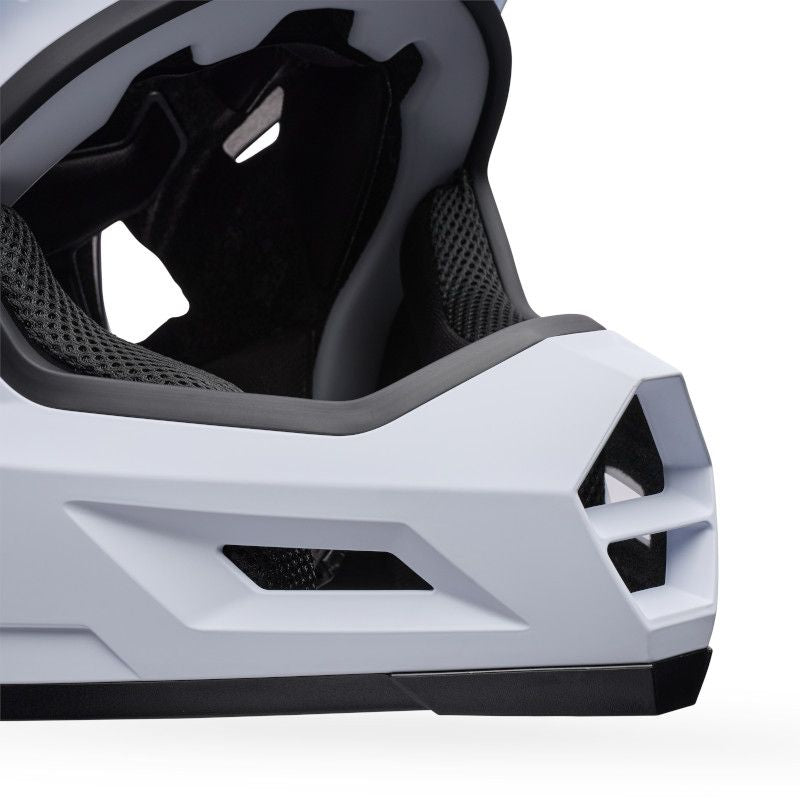 Close-up of the lower front section of the Bell Sanction 2 White helmet, highlighting its ventilation openings and black interior padding.
