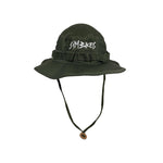 The S&M Boonie Bucket Hat features an olive green military style, chin strap, crown webbing detail, and a white stylized front logo—offering a modern twist on the classic bucket hat.