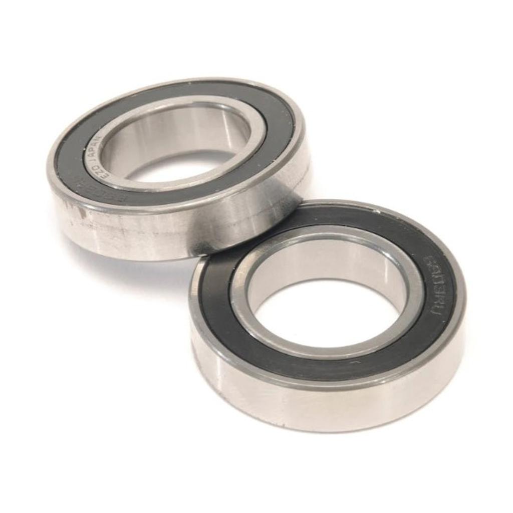 Two Eclat Exile Hub Bearing Sets with black seals are displayed, one flat and one angled—ideal for replacing rear wheel bearings.