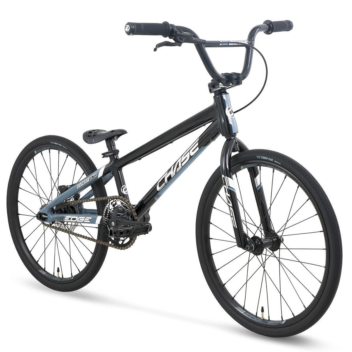 The Chase Edge Expert Race Bike (2027), featuring a lightweight aluminium frame, flat handlebars, thin tires, and an integrated head tube in black and blue, is shown against a white background.