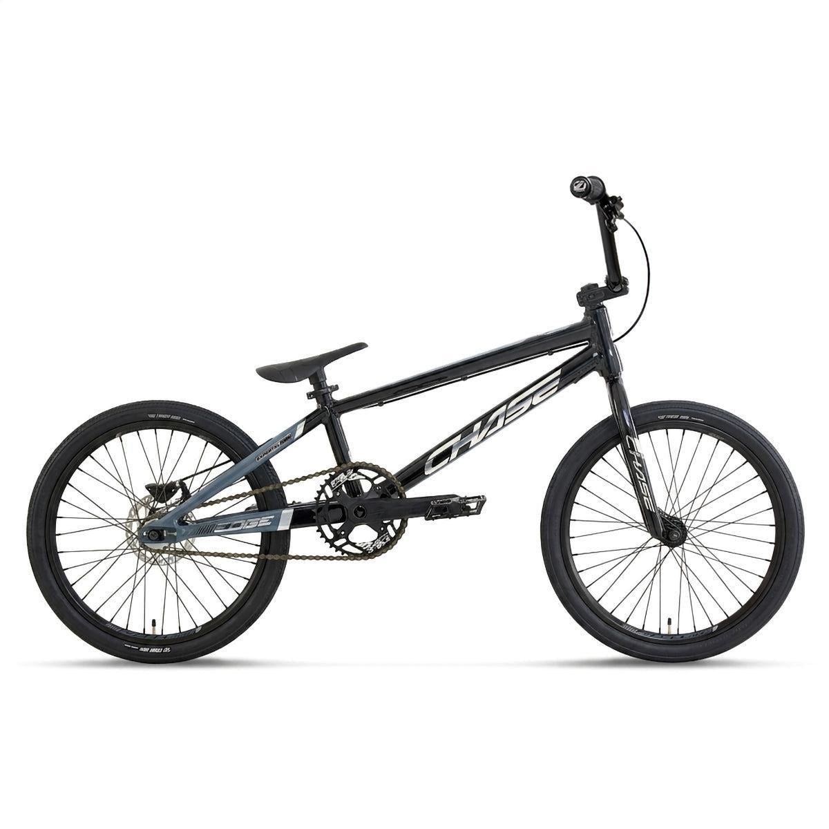 The Chase Edge Expert XL Race Bike (2027) is shown in a side view against a white background, featuring a black and gray color scheme with thin tires, flat pedals, a compact seat, and straight handlebars. This lightweight race bike boasts a hydroformed 6061 aluminum frame inspired by the Chase Edge race bike design for optimal performance.