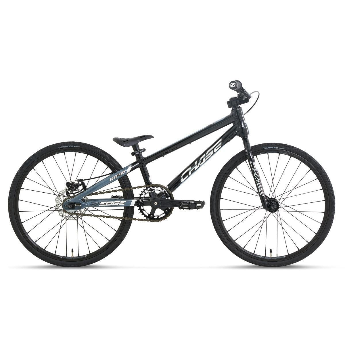 The Chase Edge Mini Race Bike (2027) is shown in matte black with a lightweight 6061 aluminium frame, thin tires, and flat handlebars, viewed from the side against a white background.