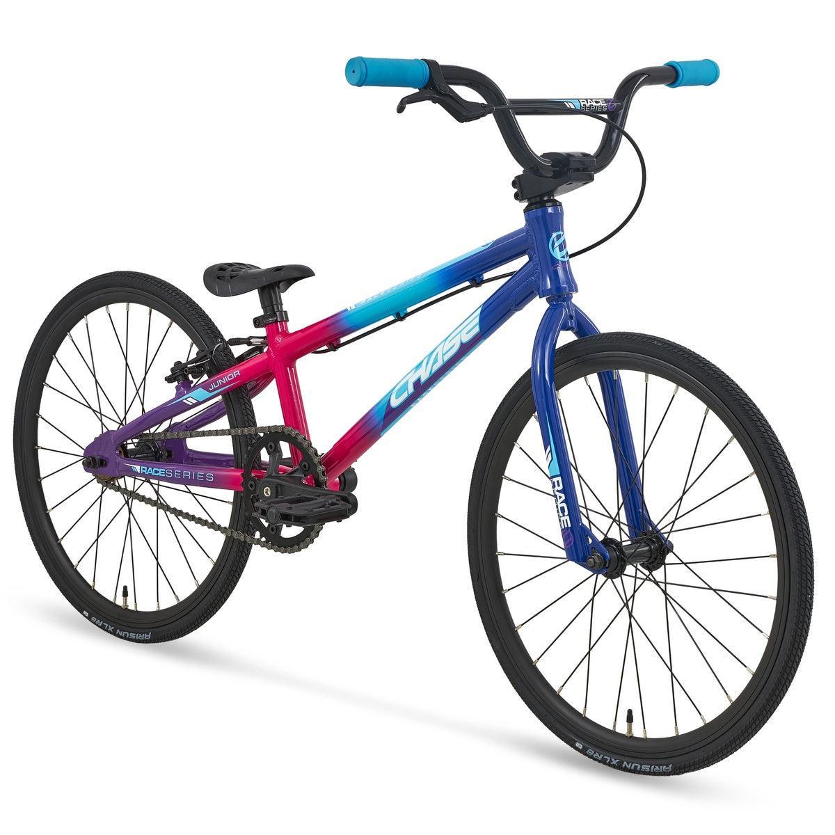 A Chase Race Series Junior Race Bike (2027) featuring a blue and pink gradient frame, black wheels, and blue handlebar grips, displayed on a white background.