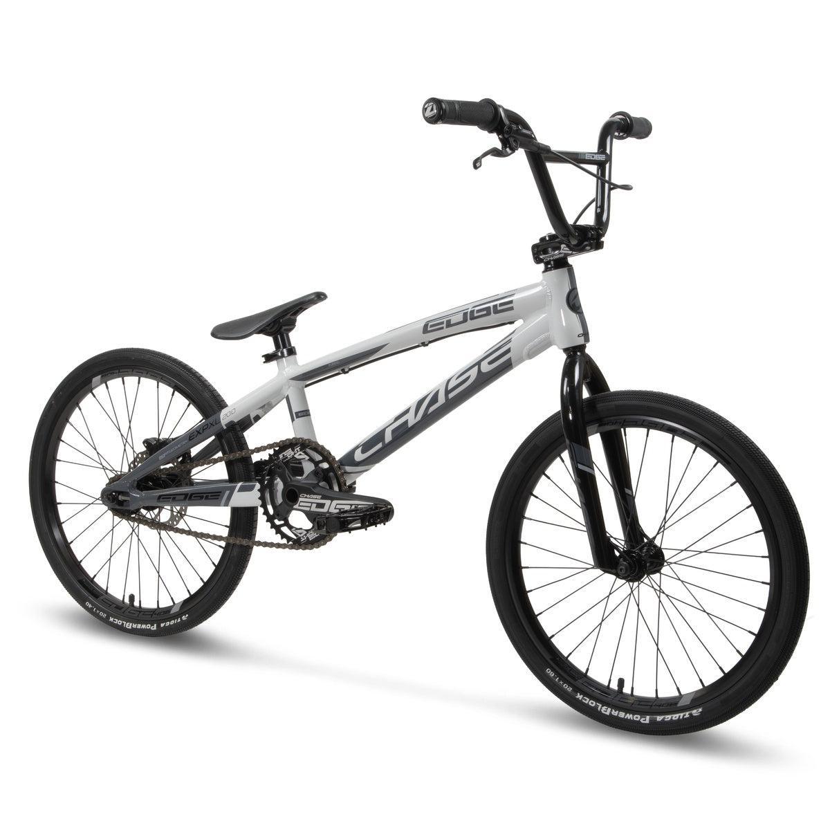 The Chase Edge Expert XL Bike (2026) features a white and black design, compact hydroformed aluminum frame, knobby tires, and flat handlebars. Shown against a plain white background.