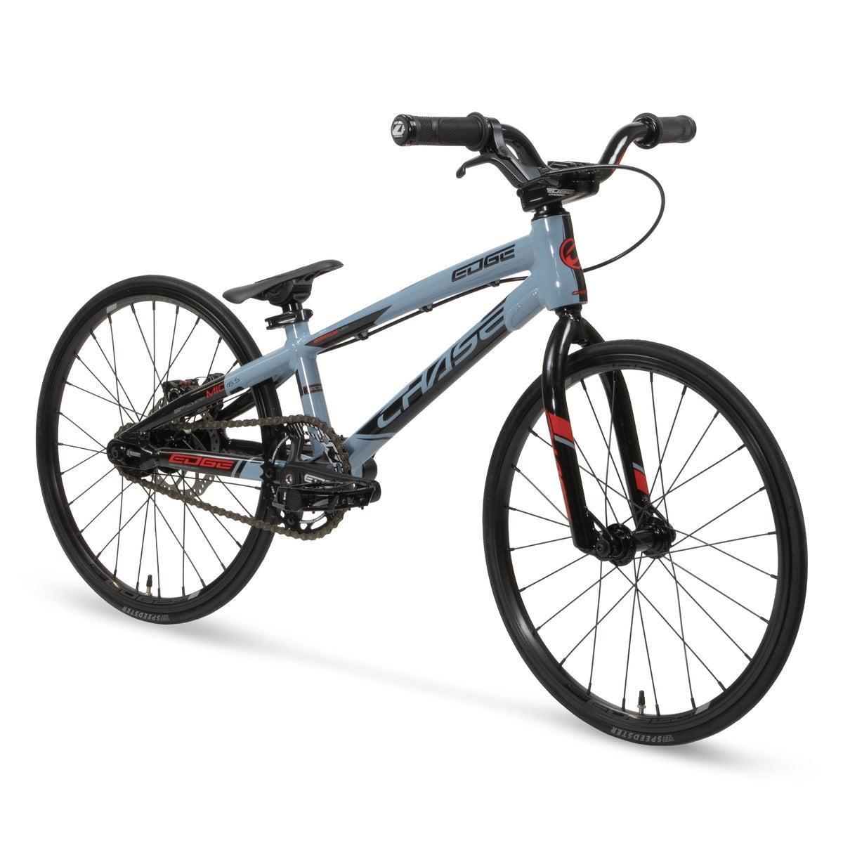 The Chase Edge Micro 18 Bike (2026) is a light blue and black BMX race bike featuring a lightweight 6061 aluminum frame, thin tires, flat handlebars, no kickstand, shown from a front-side angle.