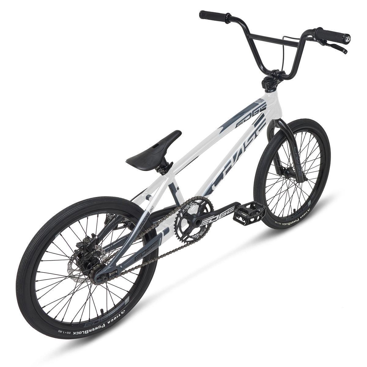 The Chase Edge Pro L Bike (2026) is a white and black BMX with large handlebars, a padded seat, thick tires, and a single gear, shown from a rear side angle.