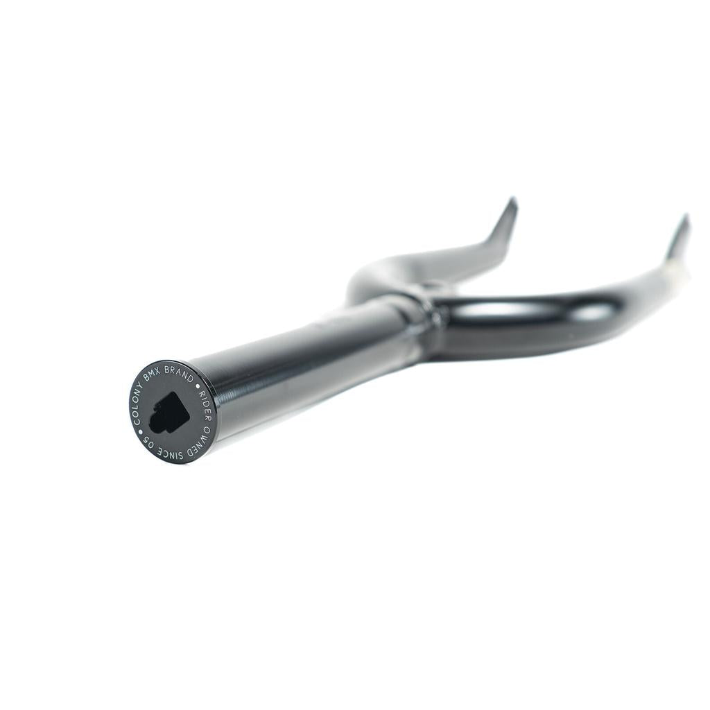 Close-up of a black Colony Cadet 16 Inch Fork with heat-treated CrMo, "COLONY BMX BRAND" and "SINCE 2005" on the end cap, 25mm offset, shown against a white background.