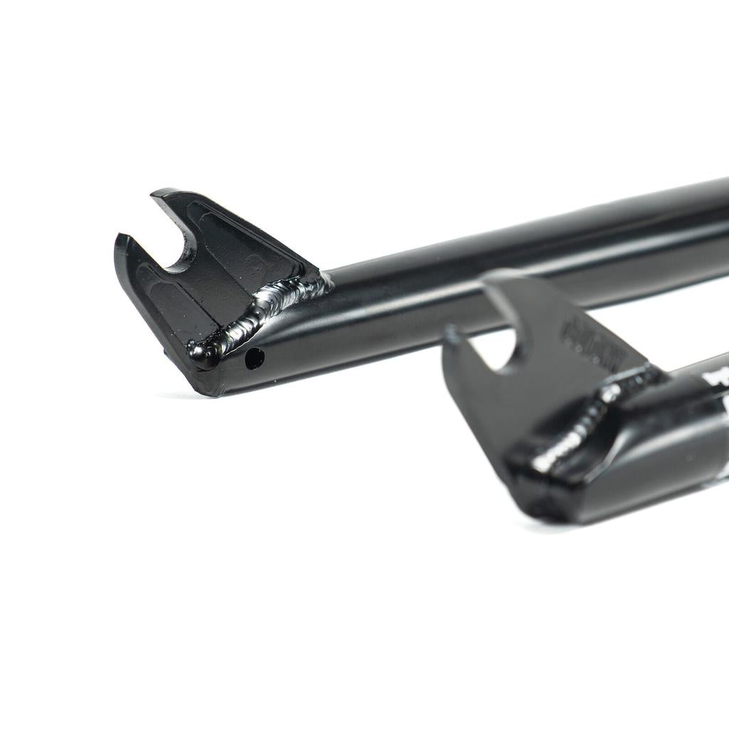 Close-up of two black Colony Guardian 20 Inch Forks dropouts made from 4130 CrMo, showing welds and precise axle slots, with quality comparable to BMX forks or CNC machined steer tubes.