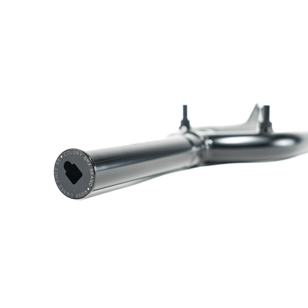 A close-up of the Colony Guardian 20 Inch Forks w/ Brake Mounts in black, shown horizontally on a white background, highlights the end cap with embossed text and hexagonal opening—ideal for front brake compatibility.