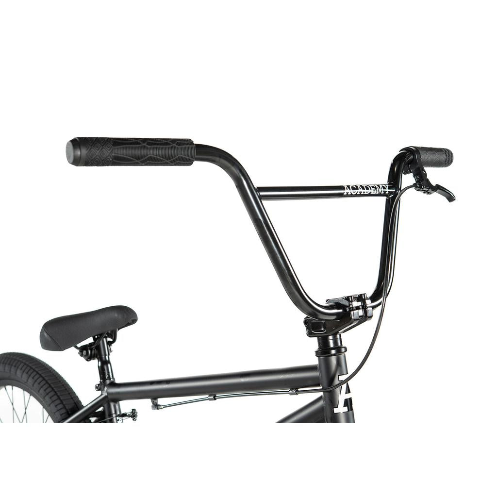 Close-up of the Academy Trooper 20 Inch Bike's black handlebars and seat, showing brake lever, grips, and frame—ideal for beginner BMX riders.