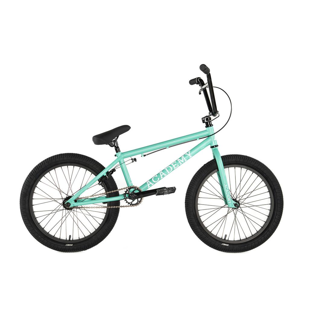The Academy Trooper 20 Inch Bike is a teal youth BMX with black tires, seat, and handlebars. "ACADEMY" is printed in white on the frame—an ideal choice for young riders trying their first BMX bike.