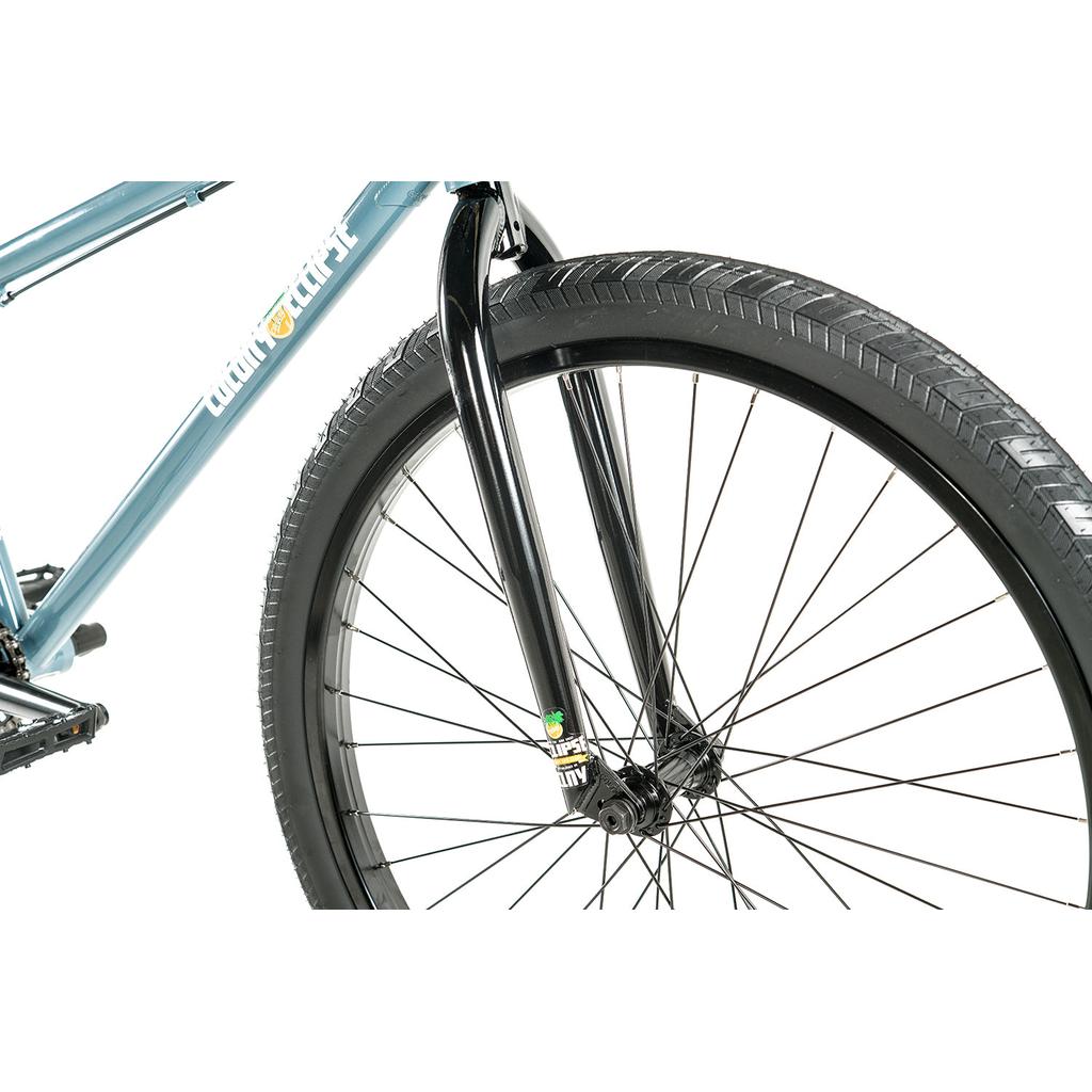 Close-up of the Colony Eclipse 26 Inch Bike’s front wheel, featuring a black fork and tire with part of the blue chromoly frame visible—ideal for cruiser or Colony Eclipse bike enthusiasts against a white background.