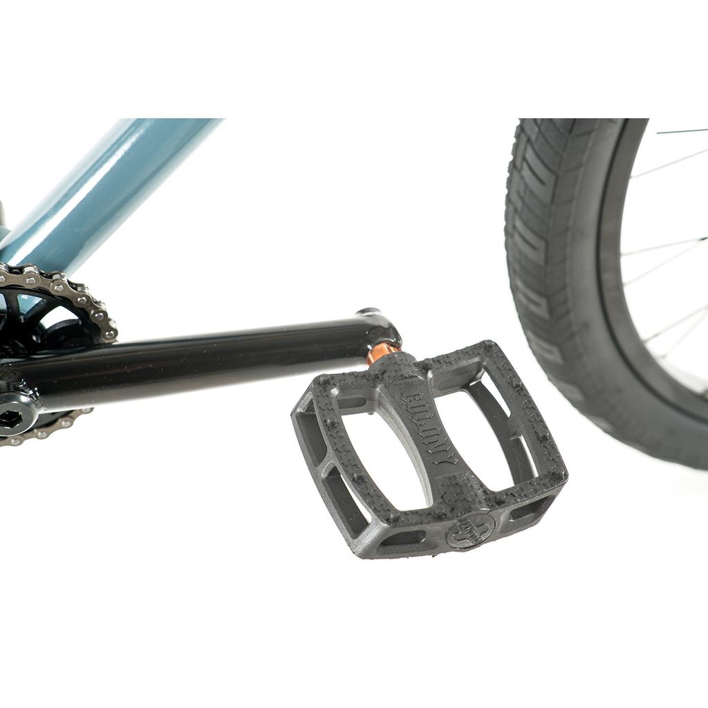 Close-up of a BMX cruiser pedal, crank arm, chain, and rear tire on the Colony Eclipse 24 Inch Bike set against a white background.